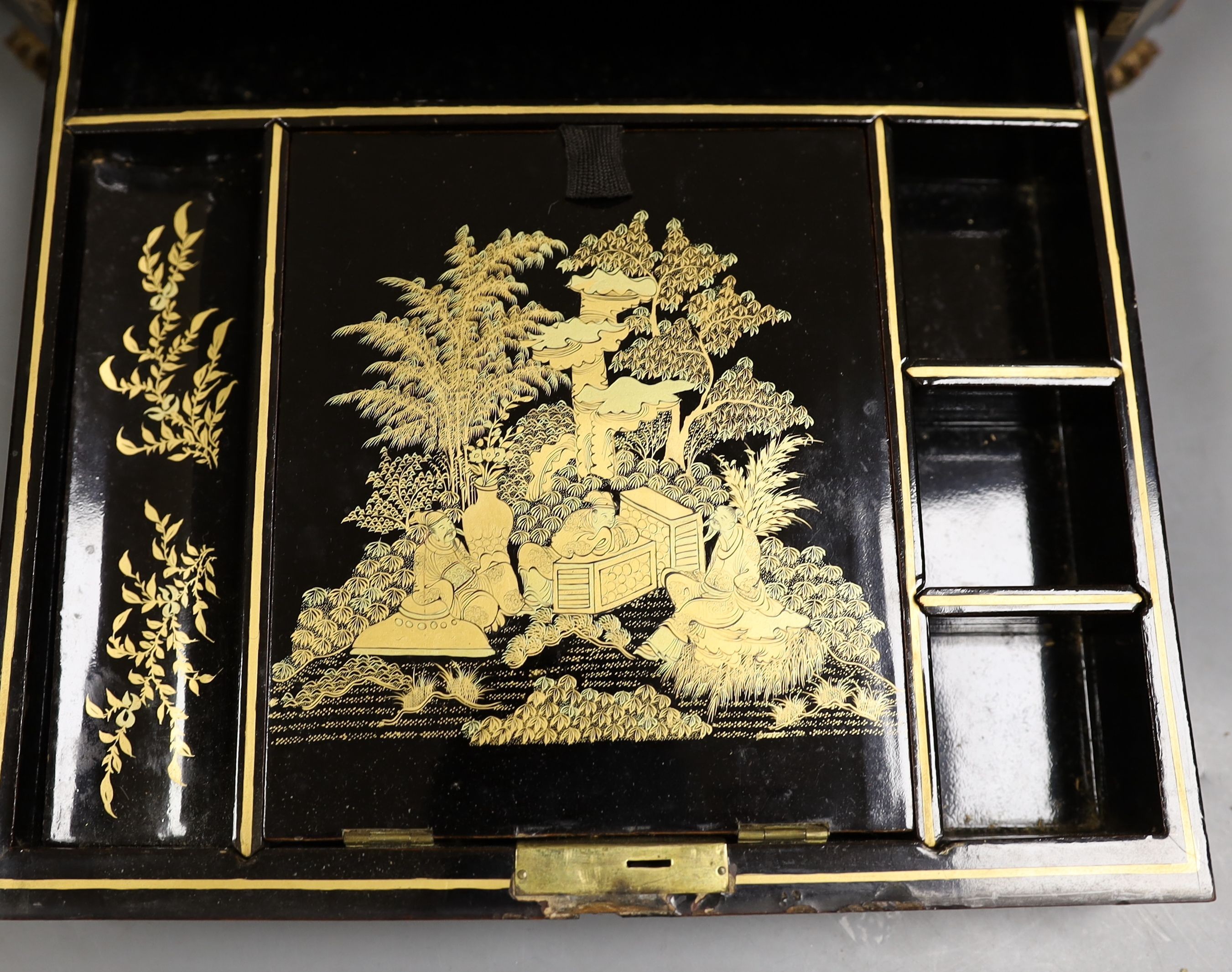 A mid 19th century Chinese Cantonese lacquer workbox with with carved Ivory sewing accessories to the interior, 37cm wide